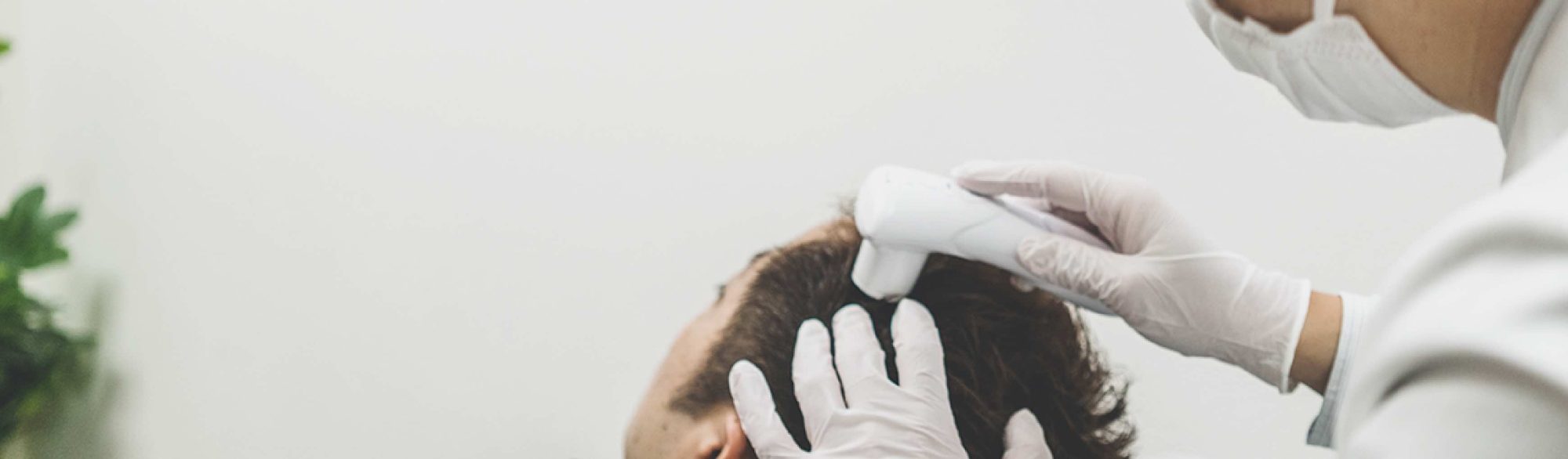 A scalp examination with a microscope at AGA Medical Care Clinic